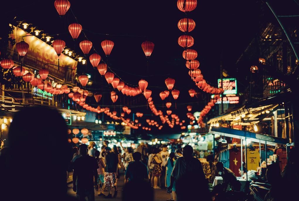 Red lanterns and people in market at night in Phu Quoc, Vietnam